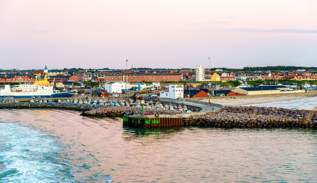 Hirtshals Hafen bei Sonnenuntergang mit lebhaften Farben und aktiver Hafenszene.